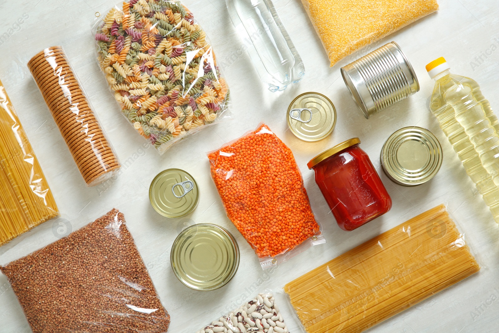 Photo of Many different products on white wooden background, flat lay. Food donation