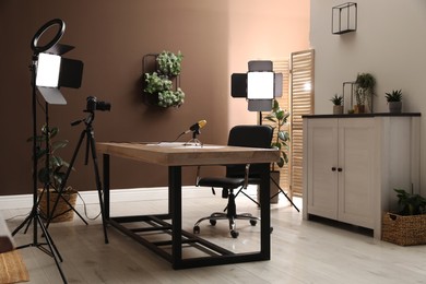 Photo of Modern blogger's workplace with professional equipment in room