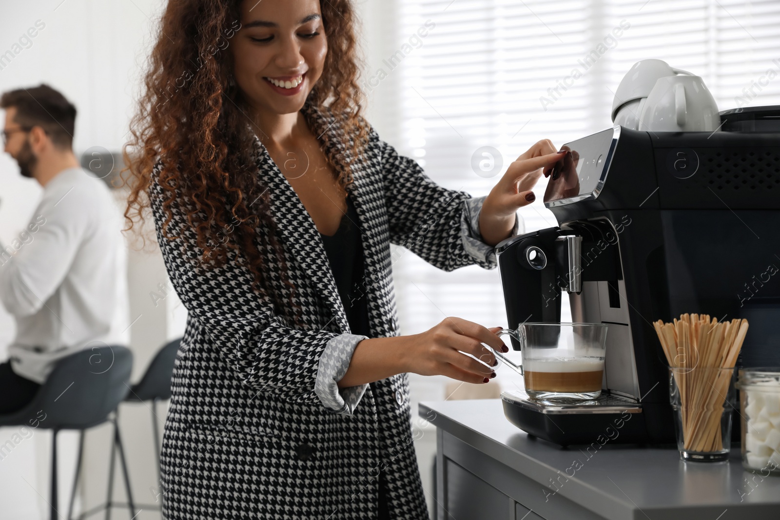 Photo of African American woman preparing fresh aromatic coffee with modern machine in office