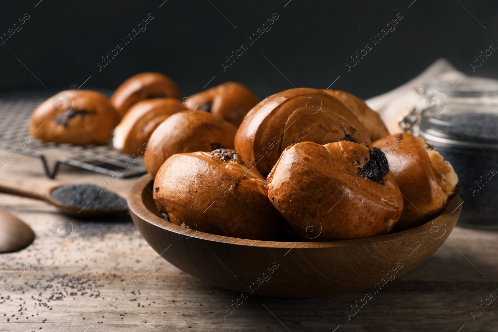 Photo of Freshly baked poppy seed buns in bowl on table