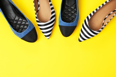 Different female shoes on color background, top view