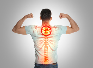 Image of Man with healthy back on light background. Spine pain prevention