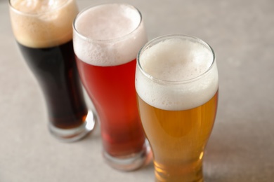 Photo of Glasses with different types of cold tasty beer on table, closeup