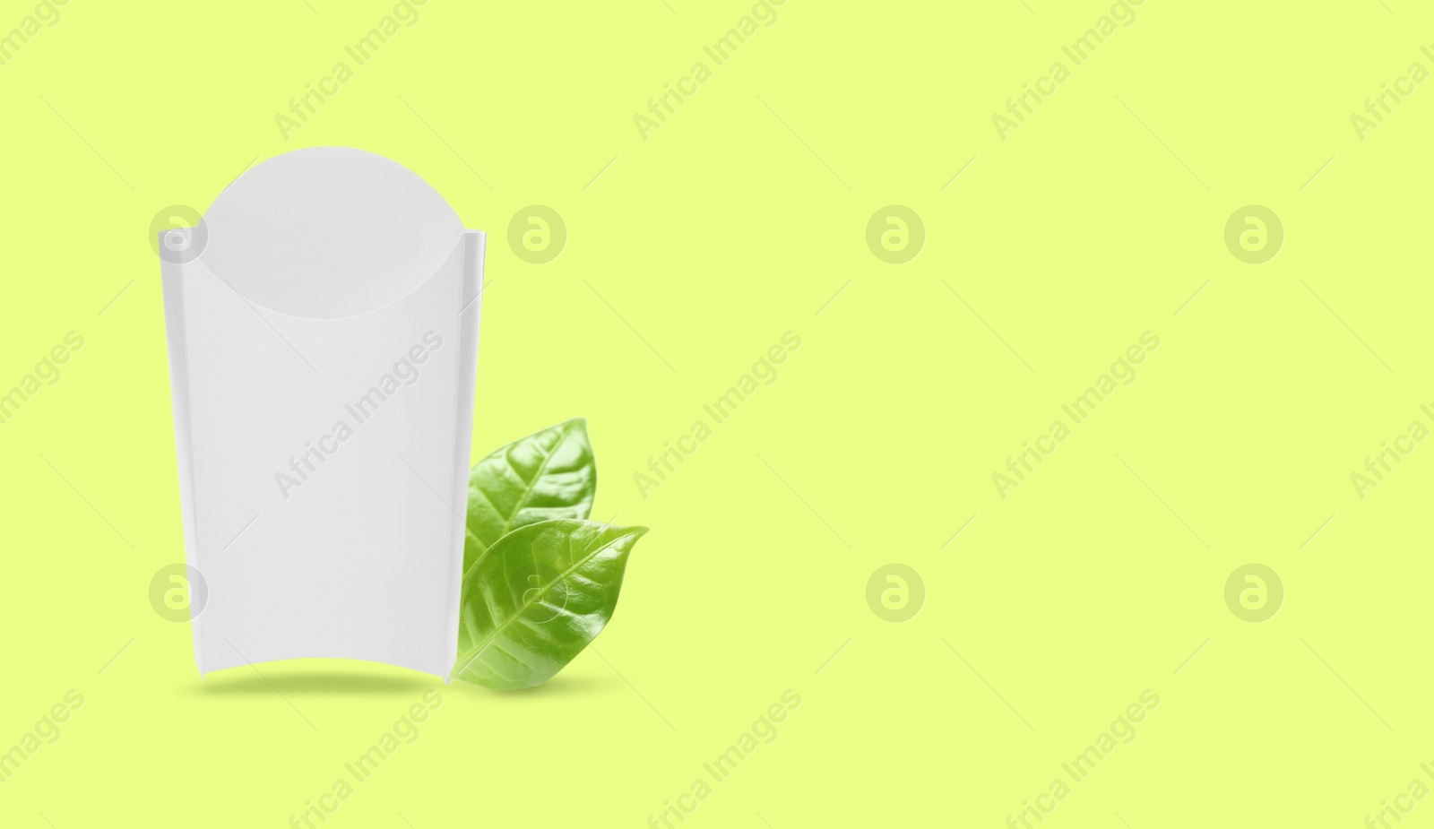 Image of Empty paper bag and green leaves on color background, space for text. Eco friendly lifestyle