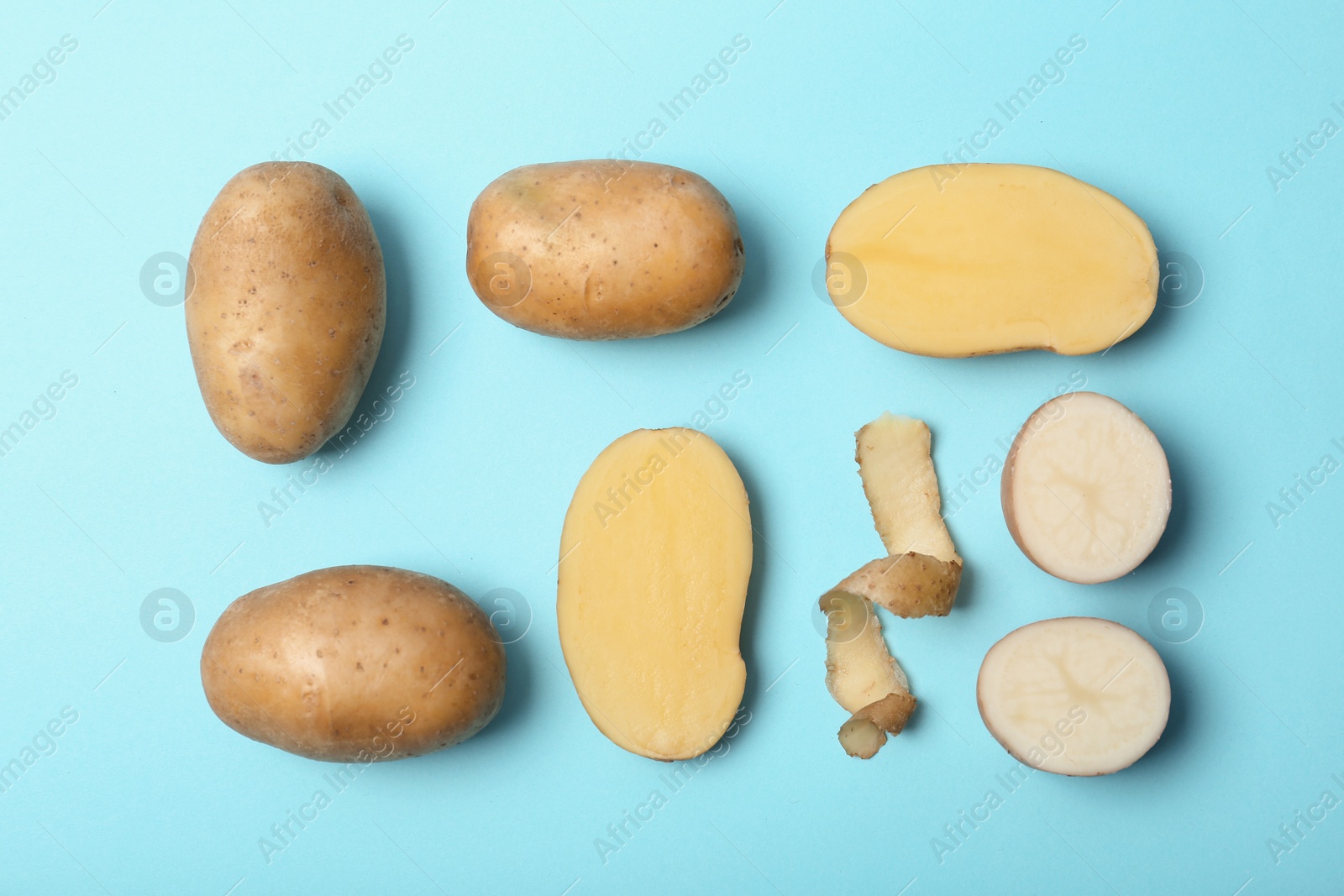 Photo of Flat lay composition with fresh ripe organic potatoes on color background