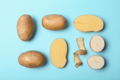 Photo of Flat lay composition with fresh ripe organic potatoes on color background