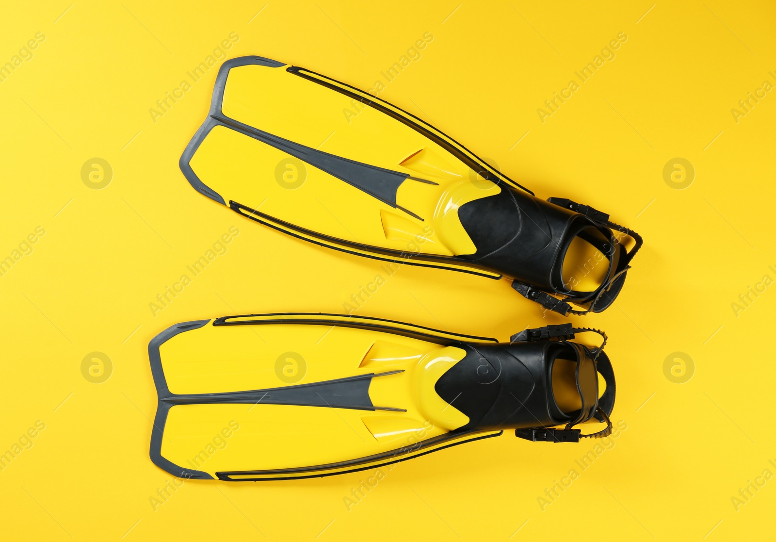 Photo of Swimming flippers on color background, top view