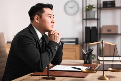 Photo of Notary working at wooden table in office