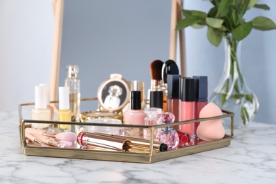 Photo of Tray with set of luxury cosmetics on dressing table
