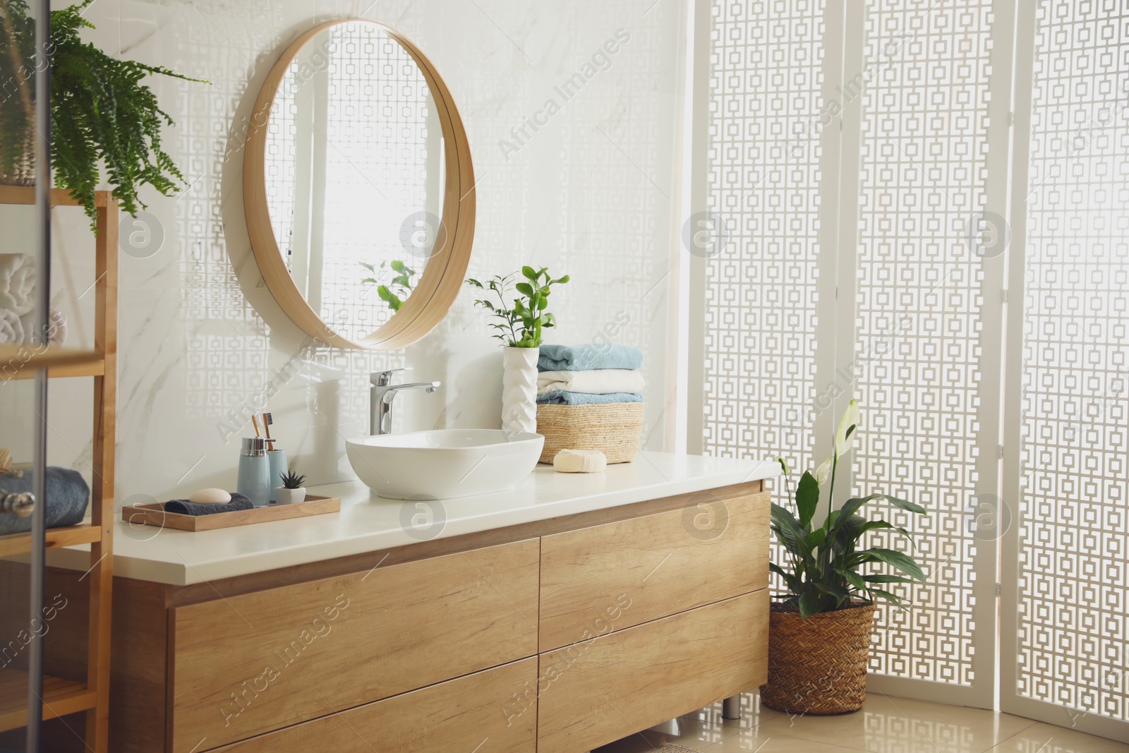 Photo of Stylish bathroom interior with mirror and countertop. Design idea