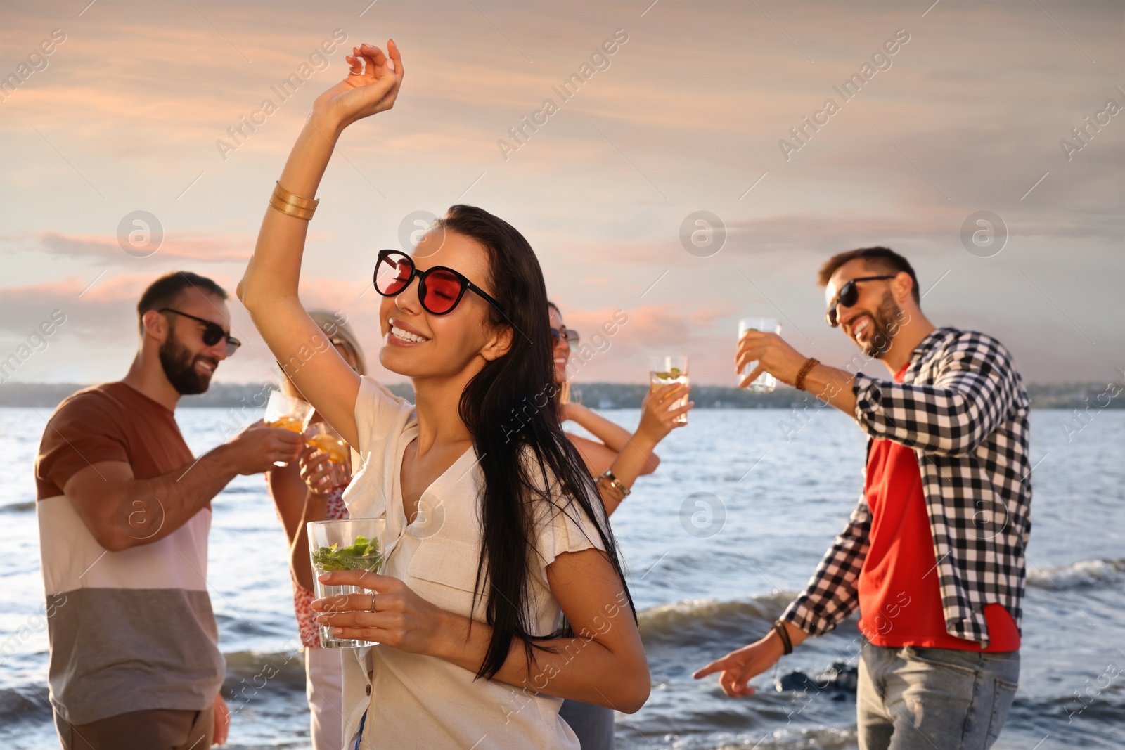 Photo of Woman with friends having fun near river at summer party