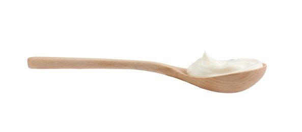 Photo of One wooden spoon with mayonnaise isolated on white