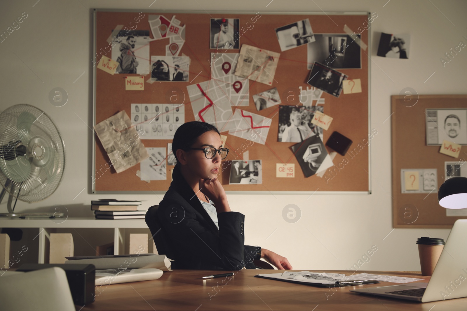 Photo of Detective working at desk in her office