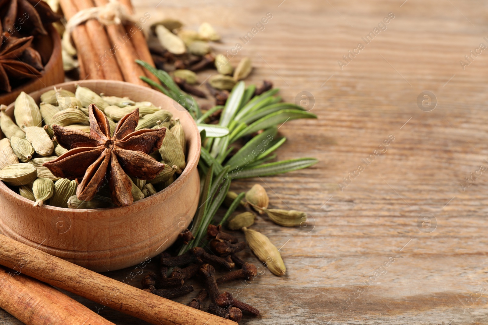 Photo of Composition with mulled wine ingredients on wooden table, closeup. Space for text