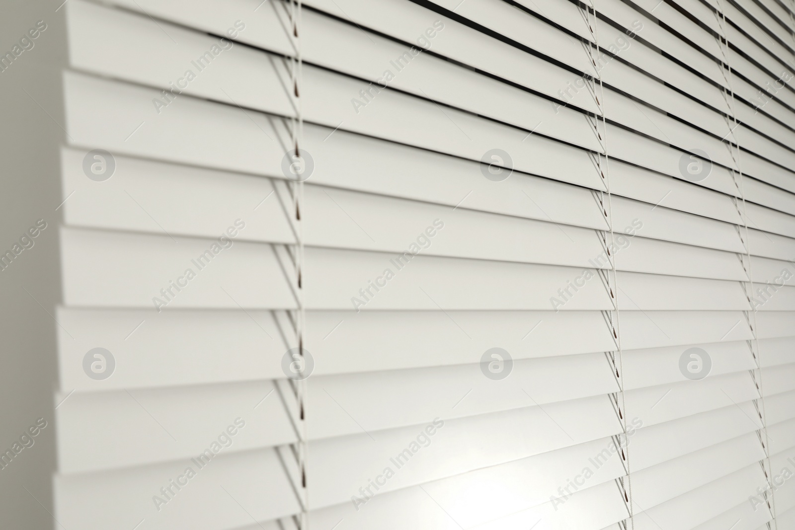 Photo of Window with closed blinds in room, closeup