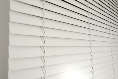 Photo of Window with closed blinds in room, closeup