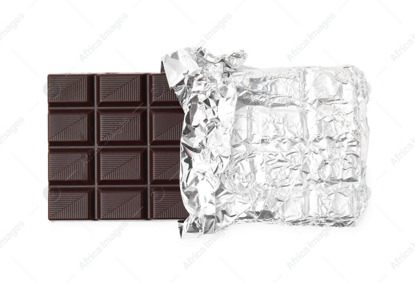 Photo of Delicious dark chocolate bar wrapped in foil isolated on white, top view