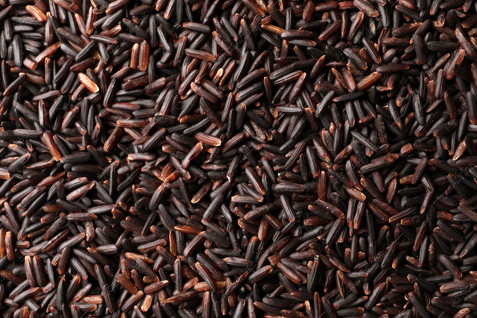 Photo of Raw brown rice as background, top view