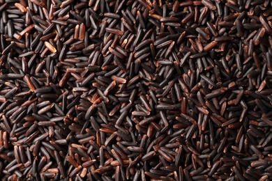 Raw brown rice as background, top view