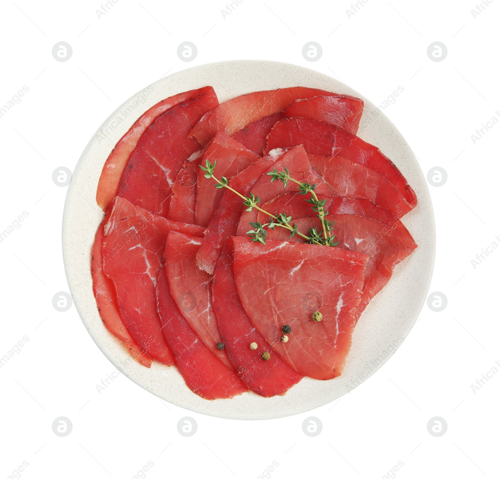 Photo of Slices of tasty bresaola and thyme isolated on white, top view