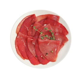 Photo of Slices of tasty bresaola and thyme isolated on white, top view