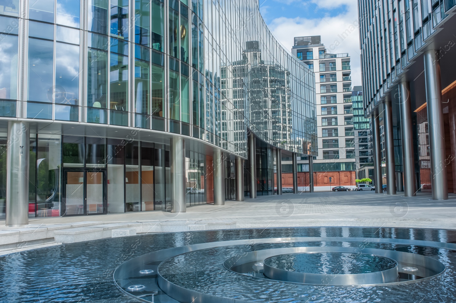 Photo of Clean water in fountain near buildings in city