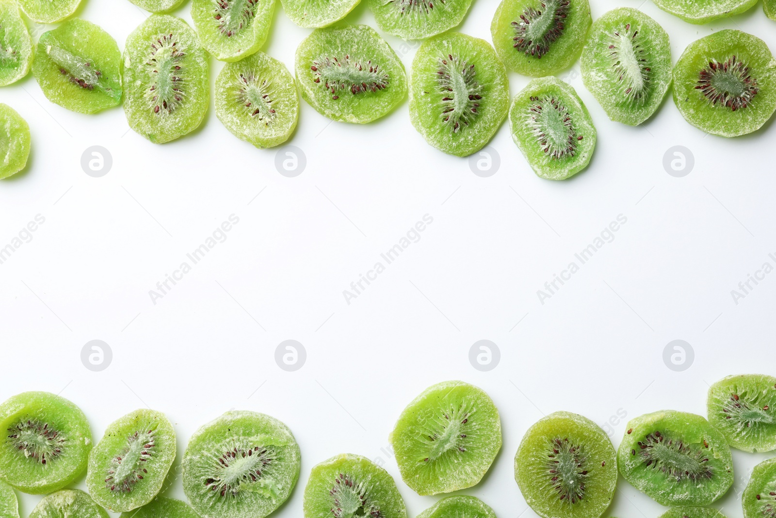 Photo of Frame made of kiwi on white background, flat lay. Dried fruit as healthy food