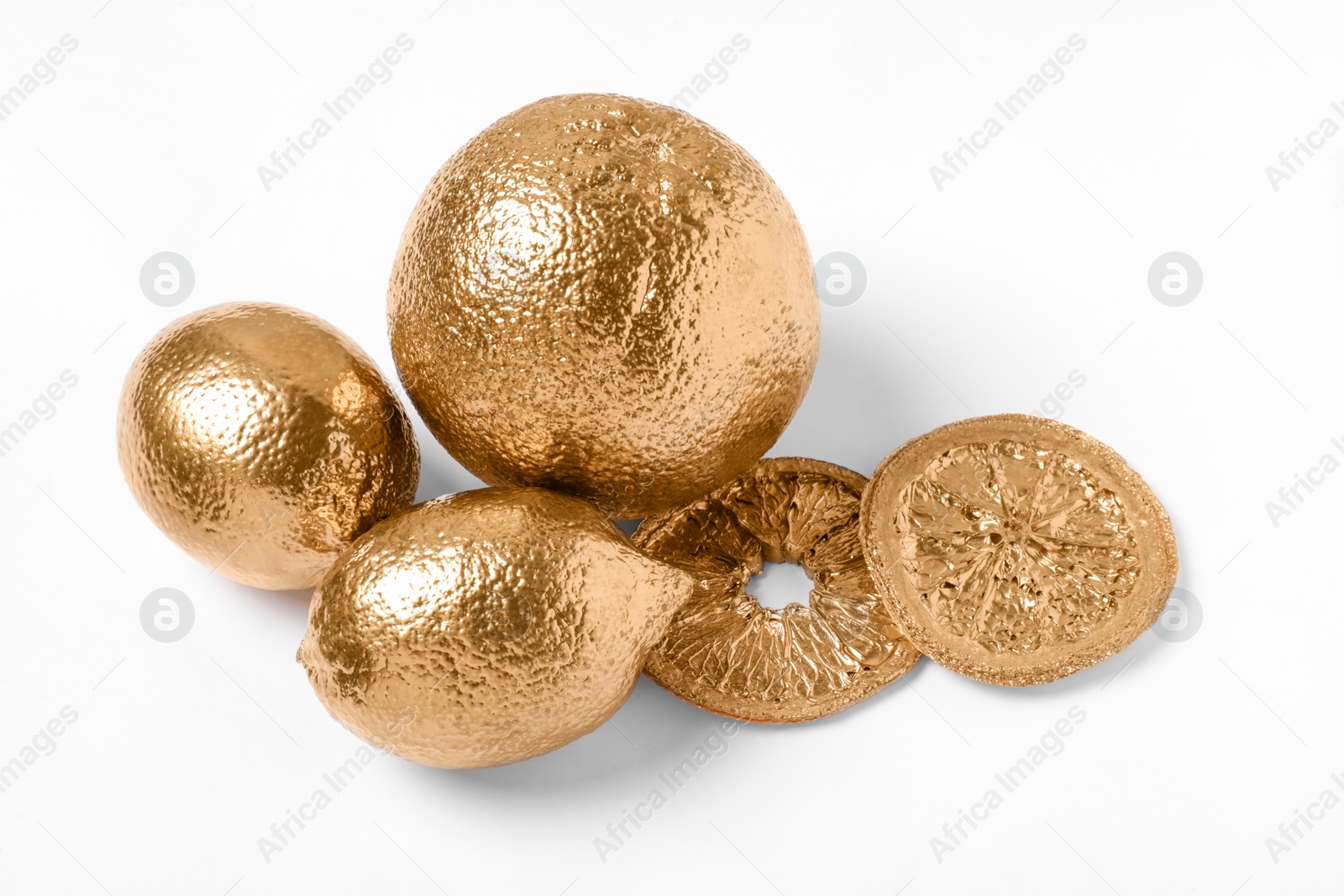 Photo of Shiny golden fruits on white background. Decor elements