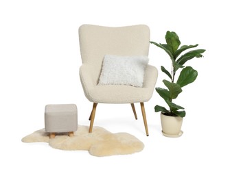 Photo of Stylish comfortable armchair with pillow, houseplant, ottoman and fluffy rug isolated on white
