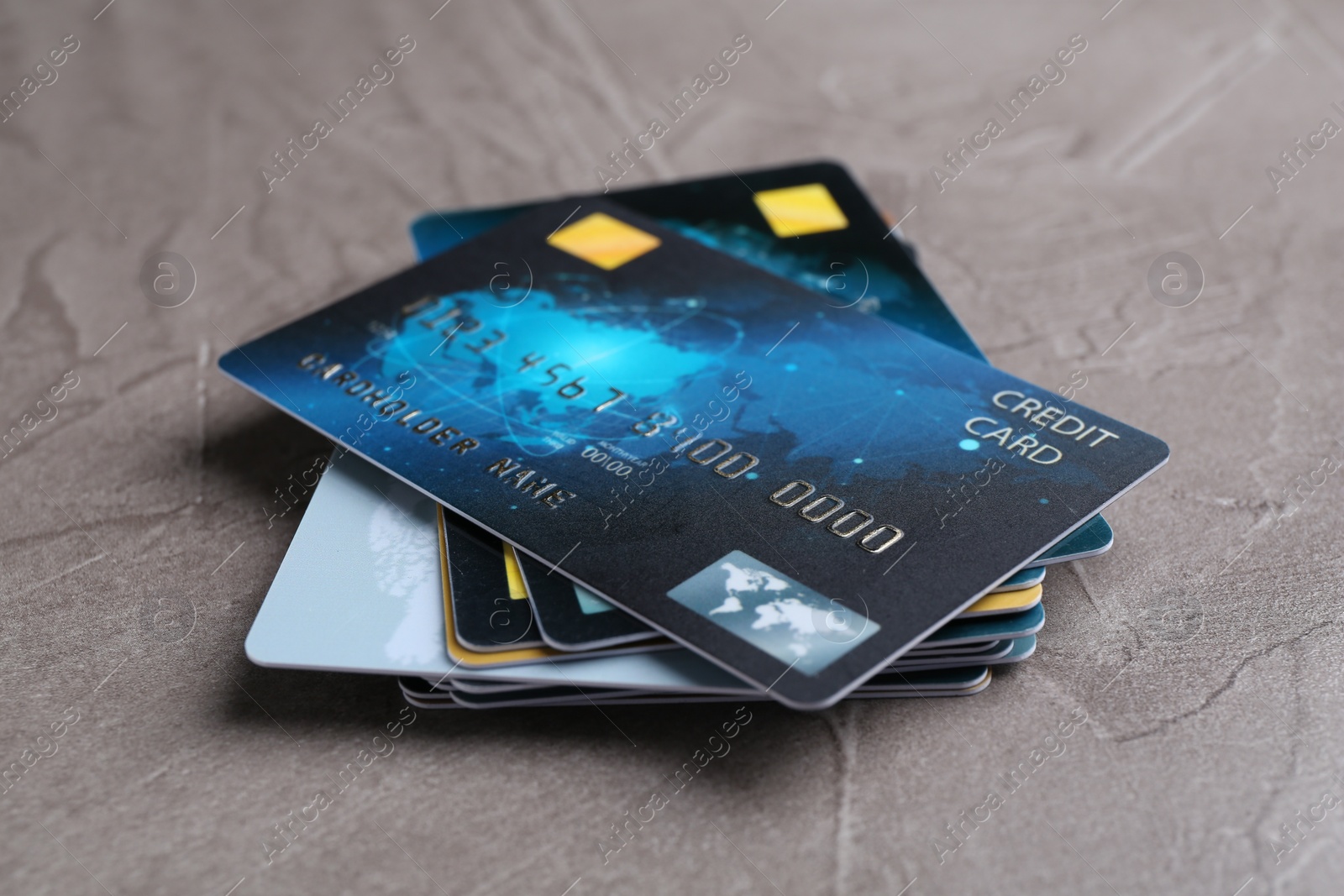 Photo of Credit cards on grey textured table, closeup