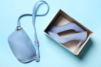 Photo of Flat lay composition with lady's shoes and bag on color background