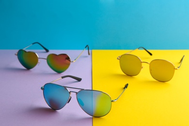 Stylish sunglasses on color background. Summer time