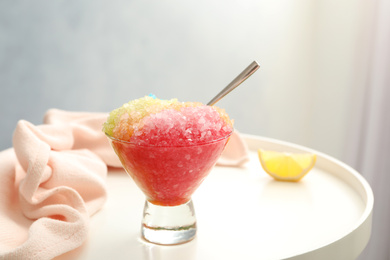 Photo of Shaving ice in glass dessert bowl on white table indoors