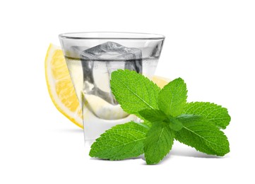 Image of Shot of vodka with ice, lemon and mint on white background
