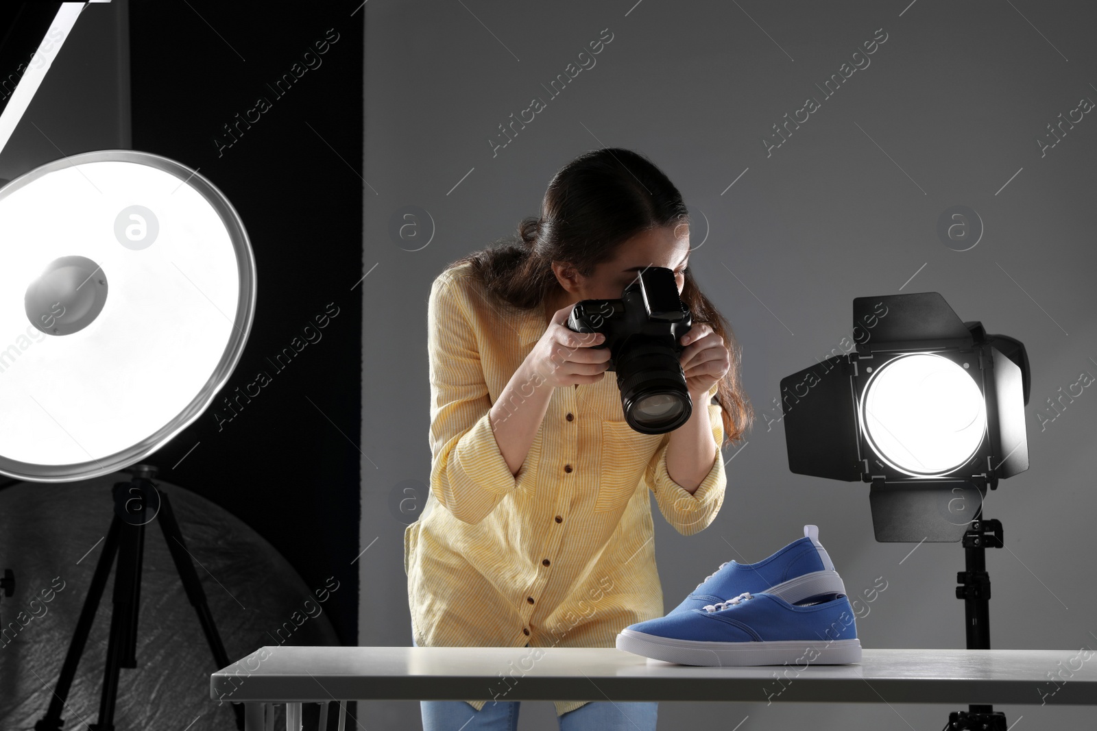Photo of Professional photographer shooting stylish shoes in studio