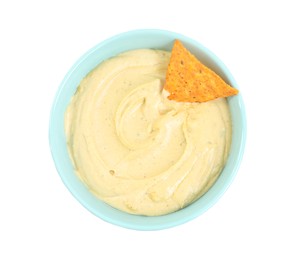 Delicious hummus with nacho chip in bowl isolated on white, top view