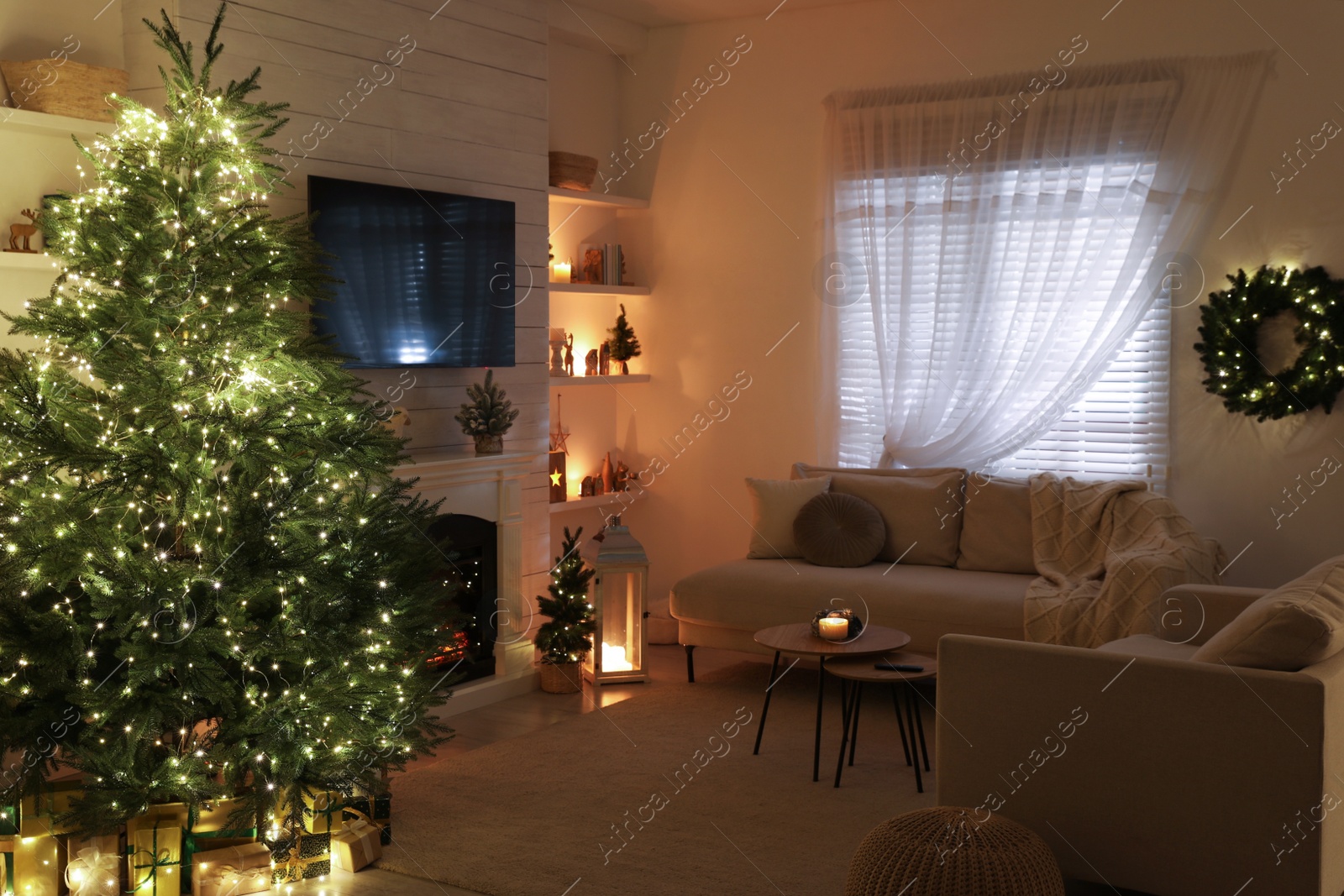 Photo of Stylish living room interior with TV set, Christmas tree and fireplace