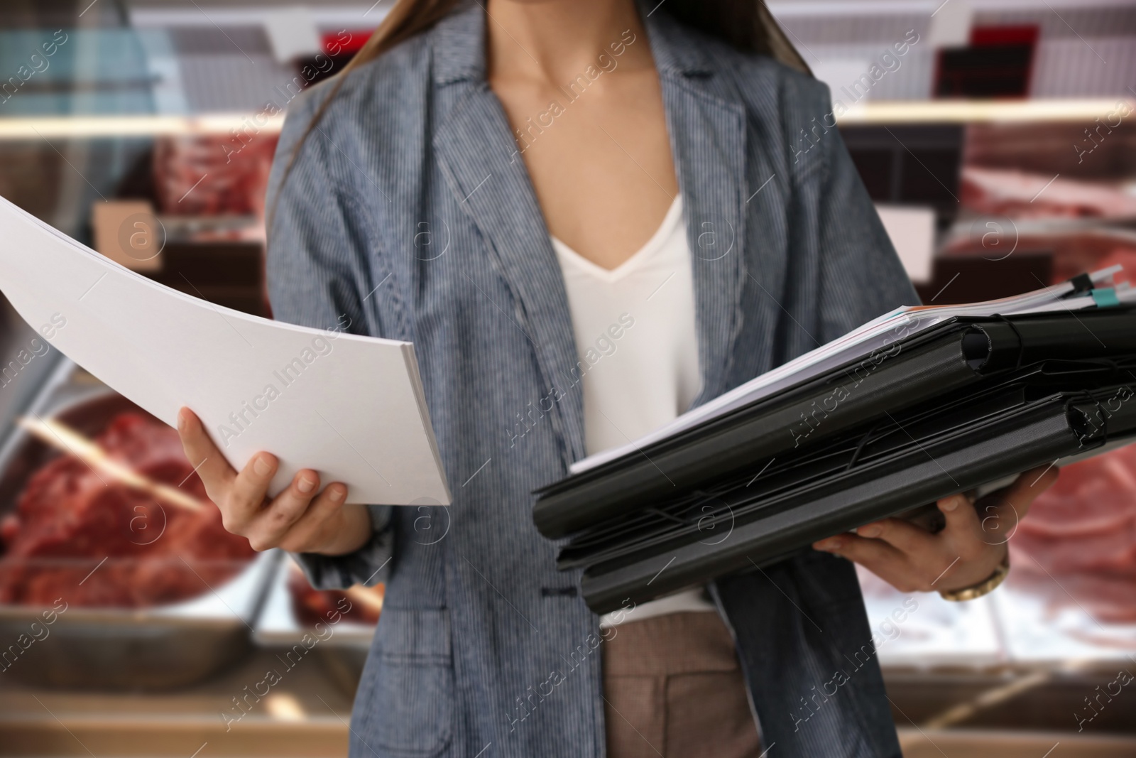 Image of Inspector with folders and documents at wholesale market, closeup. Quality control