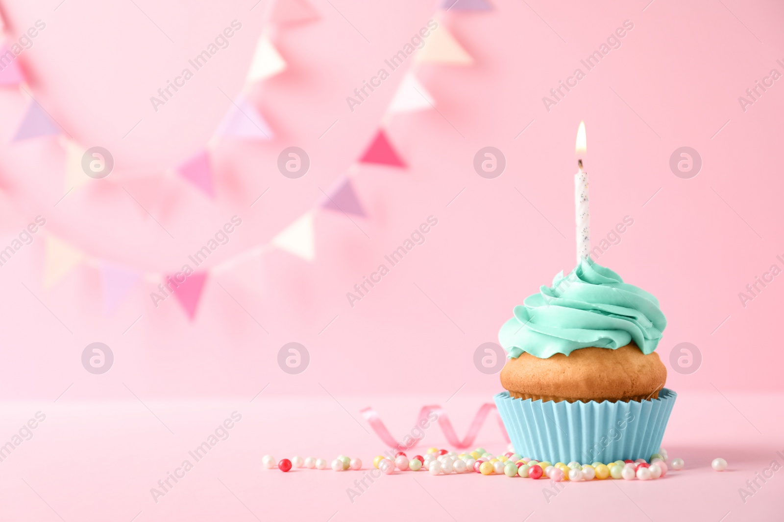 Photo of Delicious birthday cupcake with candle and space for text on color background