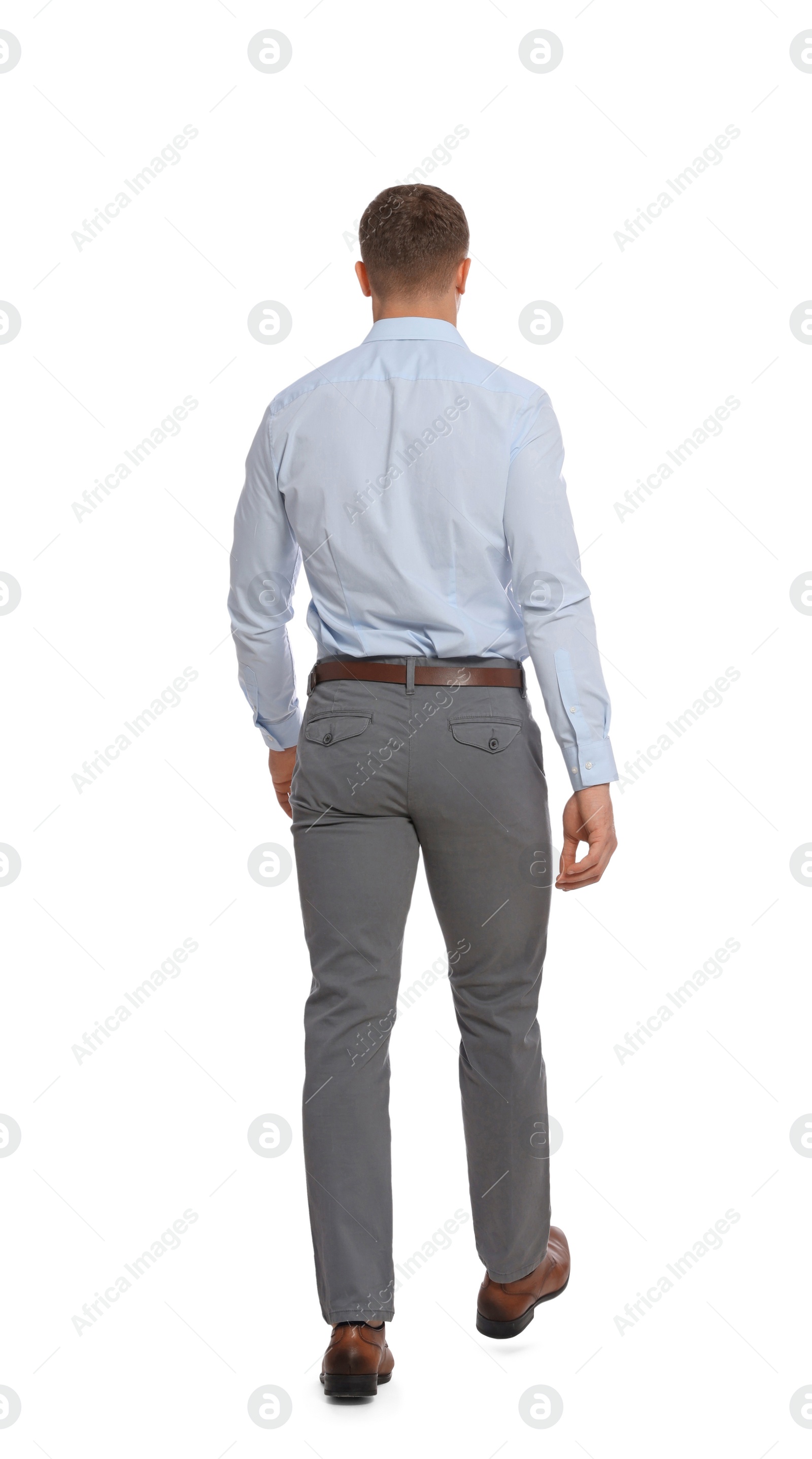 Photo of Man in formal outfit walking on white background, back view