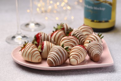 Delicious chocolate covered strawberries on light table, closeup