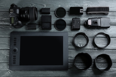 Photo of Flat lay composition with equipment for professional photographer on grey wooden table