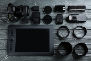 Flat lay composition with equipment for professional photographer on grey wooden table