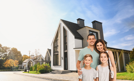 Image of Happy family smiling near their new house