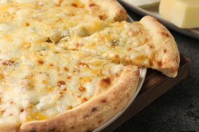 Photo of Delicious cheese pizza on dark grey table, closeup