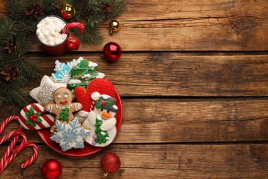 Delicious homemade Christmas cookies, cocoa and festive decor on wooden table, flat lay. Space for text