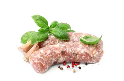 Photo of Raw homemade sausages and different spices isolated on white