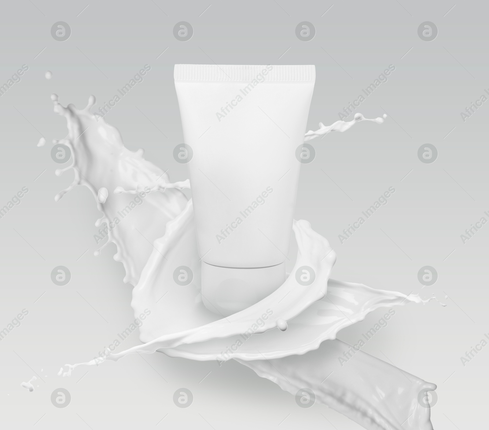 Image of Splashes of cosmetic product and tube with space for design on grey gradient background