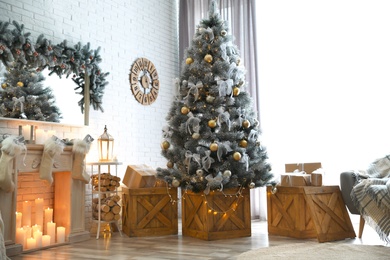 Photo of Stylish interior with decorated Christmas tree in living room