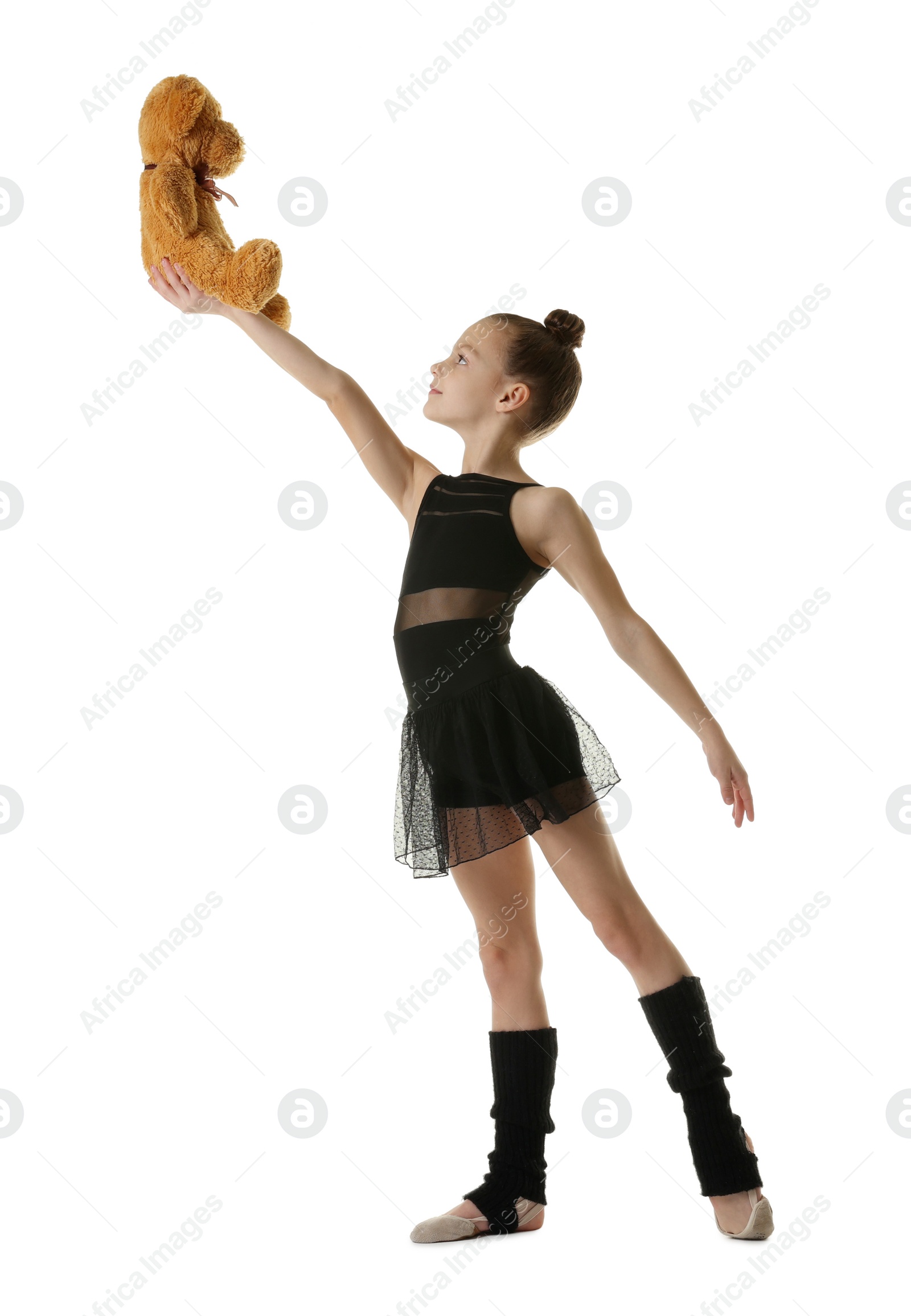 Photo of Cute little gymnast with toy bear on white background